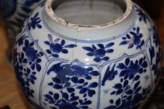 A large blue and white Chinese and a smaller similar vase with wooden cover, two stands and a cover